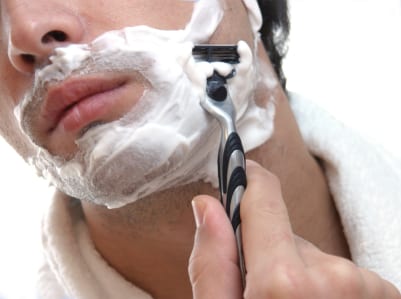 man shaving his face